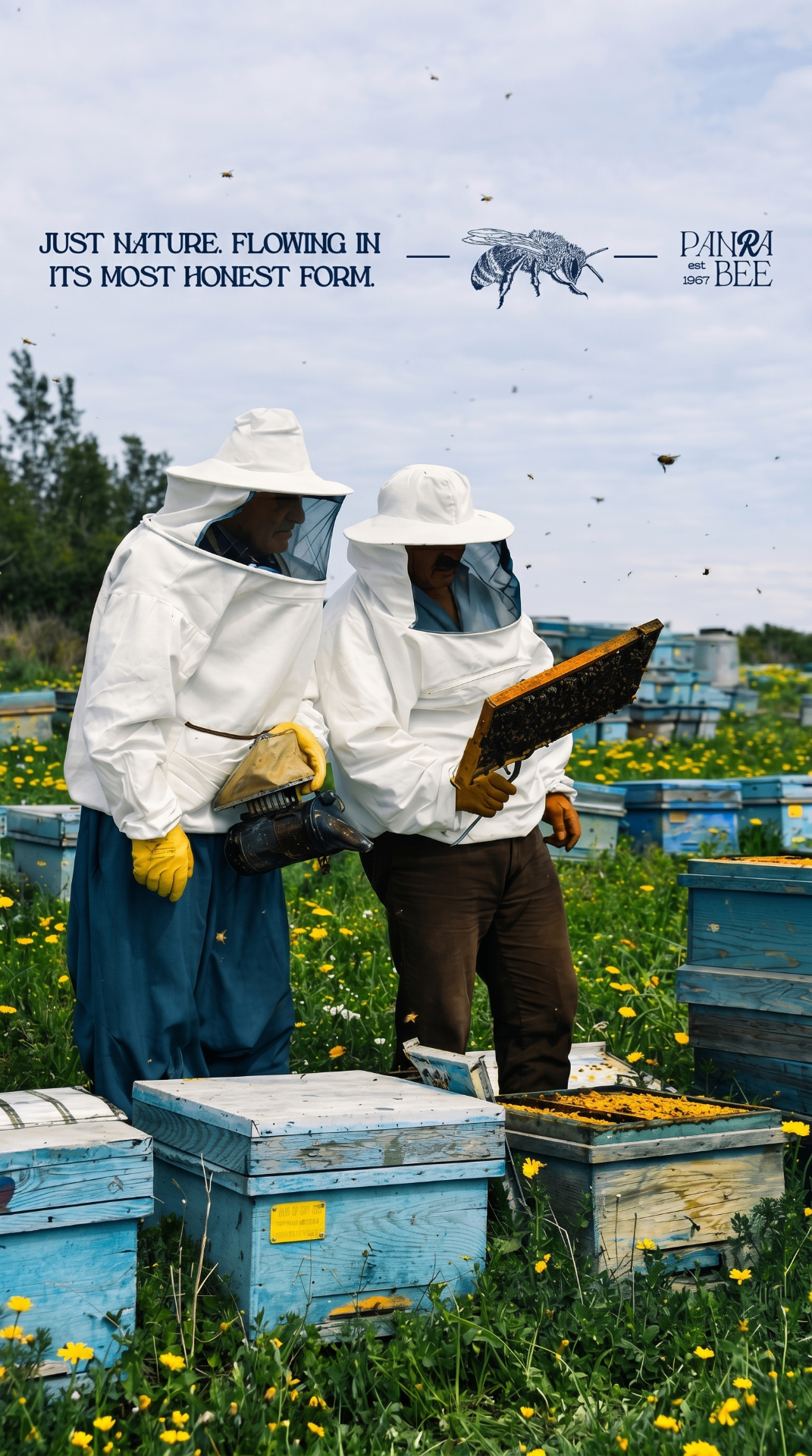 Two Panra Bee beekeepers in white suits inspecting a honeycomb frame in a wildflower meadow apiary, with the brand mark and the words Just nature. Flowing in its most honest form.
